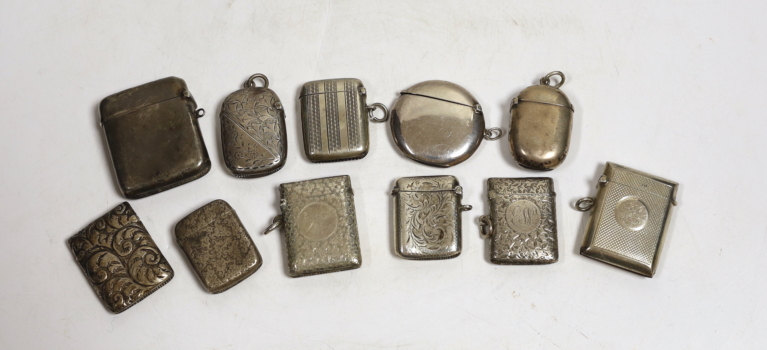 Nine assorted mainly early 20th century silver vesta cases and one similar white metal vesta case, largest 52mm.